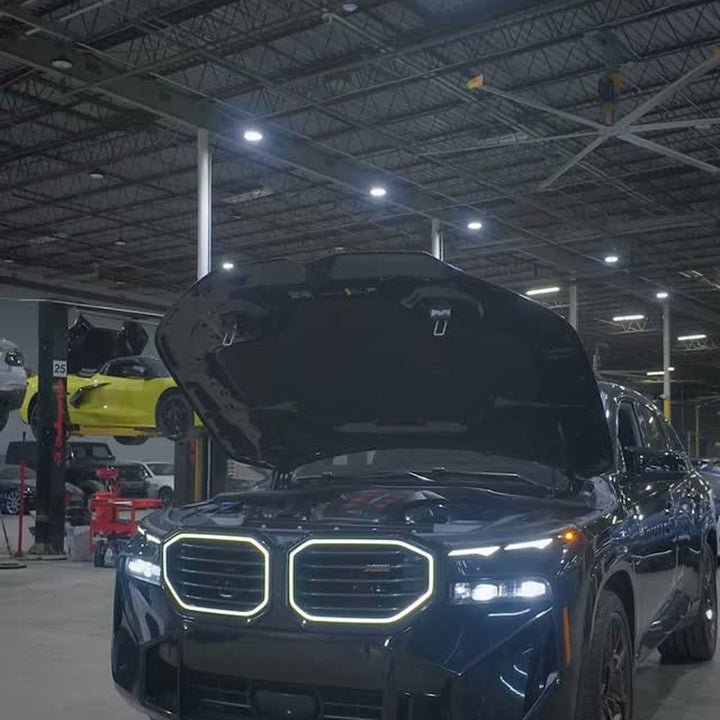 Instagram reel: BMW XM with the hood open during a carbon intake installation
