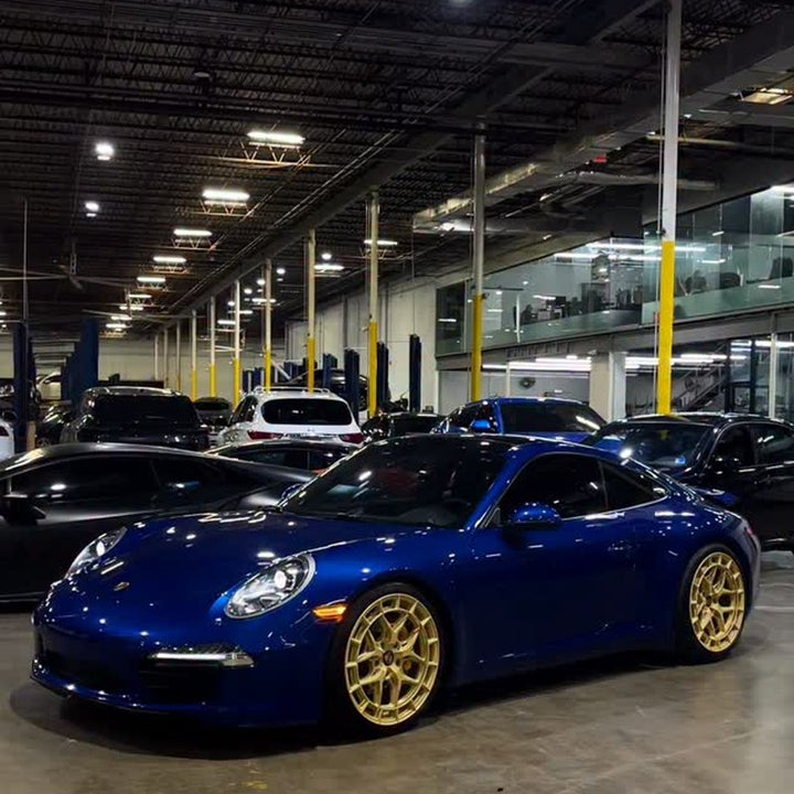 Instagram reel: Blue Porsche 911 on gold wheels in the Project Gamma shop