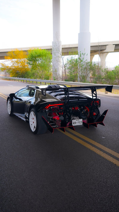 Rear three-quarter view of a black Lamborghini Huracán running a Project Gamma twin turbo kit