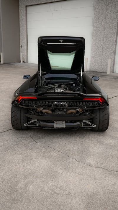 Black Lamborghini Huracán photographed from the rear with the engine lid open