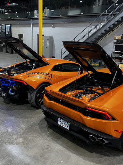 Orange Lamborghini Huracán with its engine cover open during a twin turbo installation