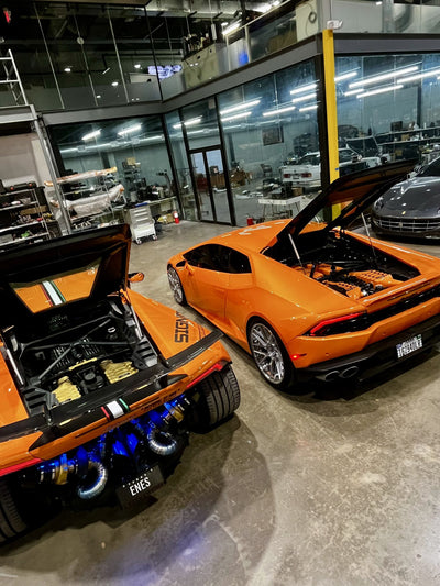 Twin turbo installation in progress on an orange Lamborghini Huracán in the workshop