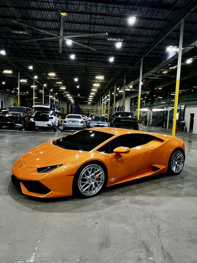 Orange Lamborghini Huracán parked in the Project Gamma workshop