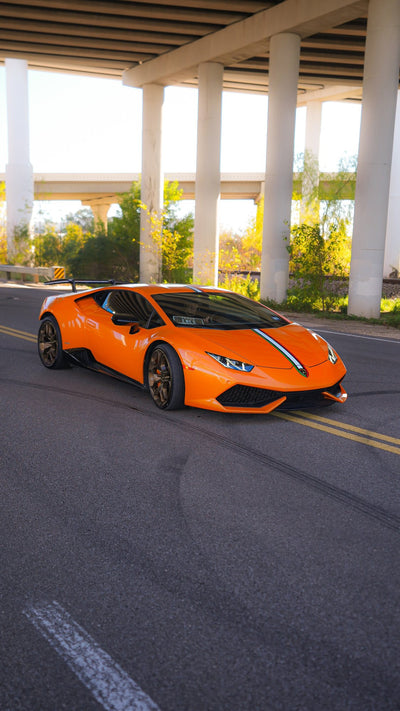 Orange Lamborghini Huracán driving on the road after a Project Gamma twin turbo conversion