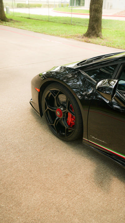 Side detail of a black Lamborghini Huracán Performante with red brake calipers